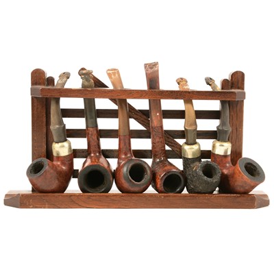 Lot 220 - A five space pipe rack and collection of smokers pipes.