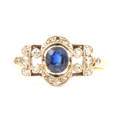 Lot 48 - A diamond and blue stone cluster ring.