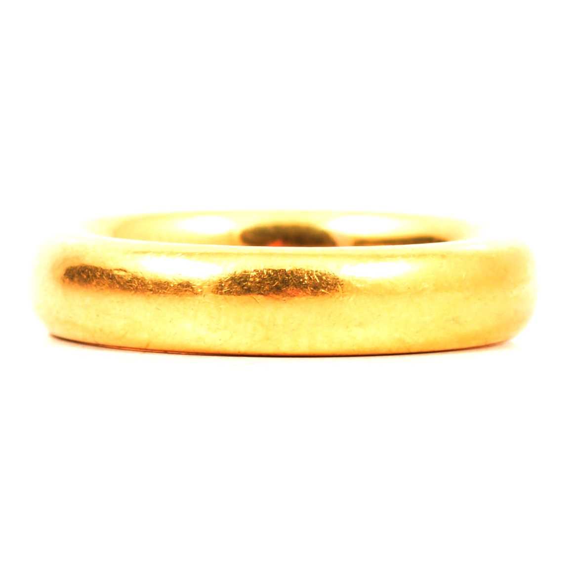 Lot 121 - A 22 carat yellow gold wedding band.