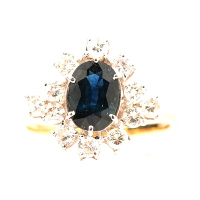 Lot 43 - A sapphire and diamond cluster ring.