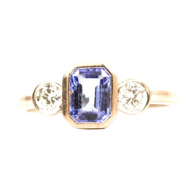 Lot 33 - A tanzanite and diamond three stone ring.