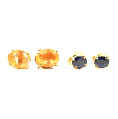 Lot 197 - A pair of yellow citrine earstuds and a pair of blue sapphire earstuds.