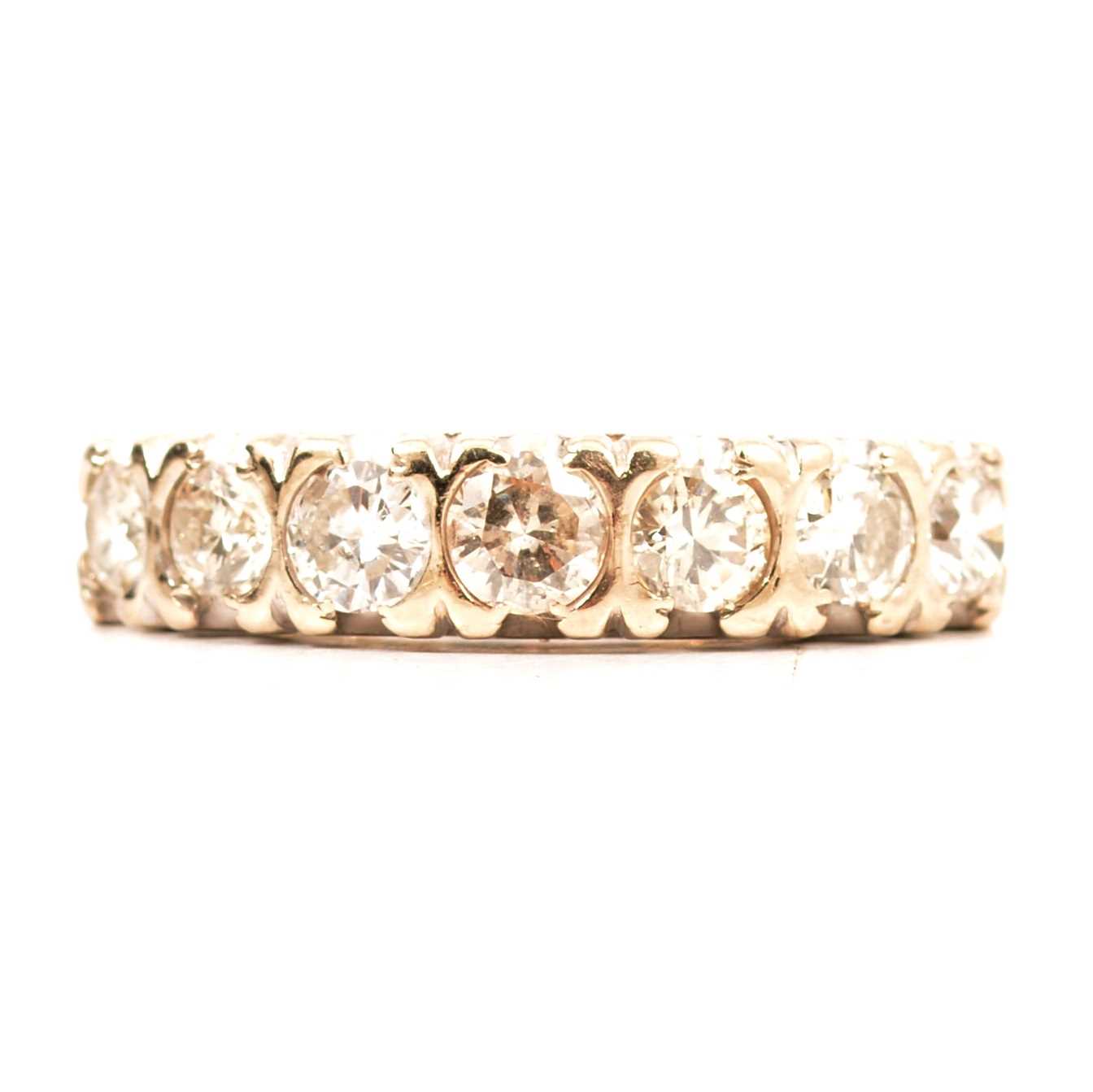 Lot 61 - A diamond half eternity ring.