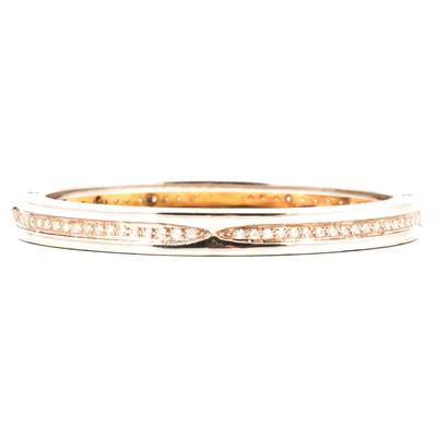 Lot 244 - Bvlgari - A b.zero1 steel and gold bangle aftermarket set with diamonds.