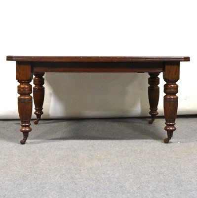 Lot 444 - Edwardian oak wind-out dining table