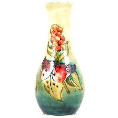 Lot 10 - A Moorcroft tall baluster vase in the Aurum Lily design.
