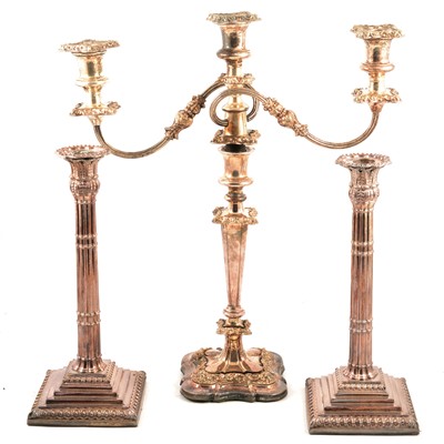 Lot 112 - Pair of electroplated candlesticks and a candelabra