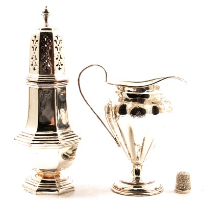 Lot 334 - Georgian style silver sugar sifter, silver cream jug, and a thimble.