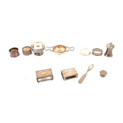 Lot 340 - Four silver napkin rings, two matchbox holders, tea strainer and bowl, pepper pot, pill box ,spoon.