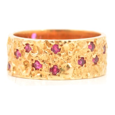 Lot 111 - An 18 carat yellow gold band set with rubies.