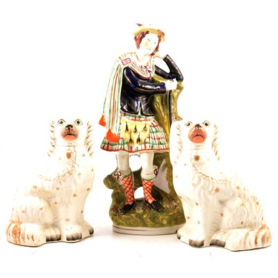 Lot 41 - Staffordshire pottery Scotsman and a pair of dogs