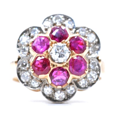 Lot 5 - A ruby and diamond reverse cluster floral ring.