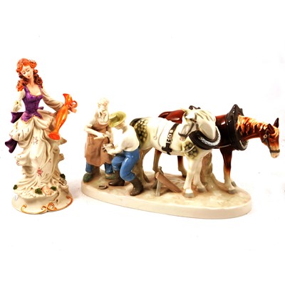 Lot 55 - Continental porcelain group of farriers and shire horses, pair of bisque figures, cat and donkey.