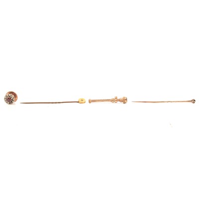 Lot 175 - A pink stone and diamond stick pin, a small diamond set tie pin and a yellow metal toothpick.