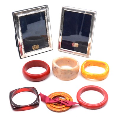 Lot 475 - Five vintage bakelite bangles, bakelite scarf ring, puzzle ring, and silver photograph frames.