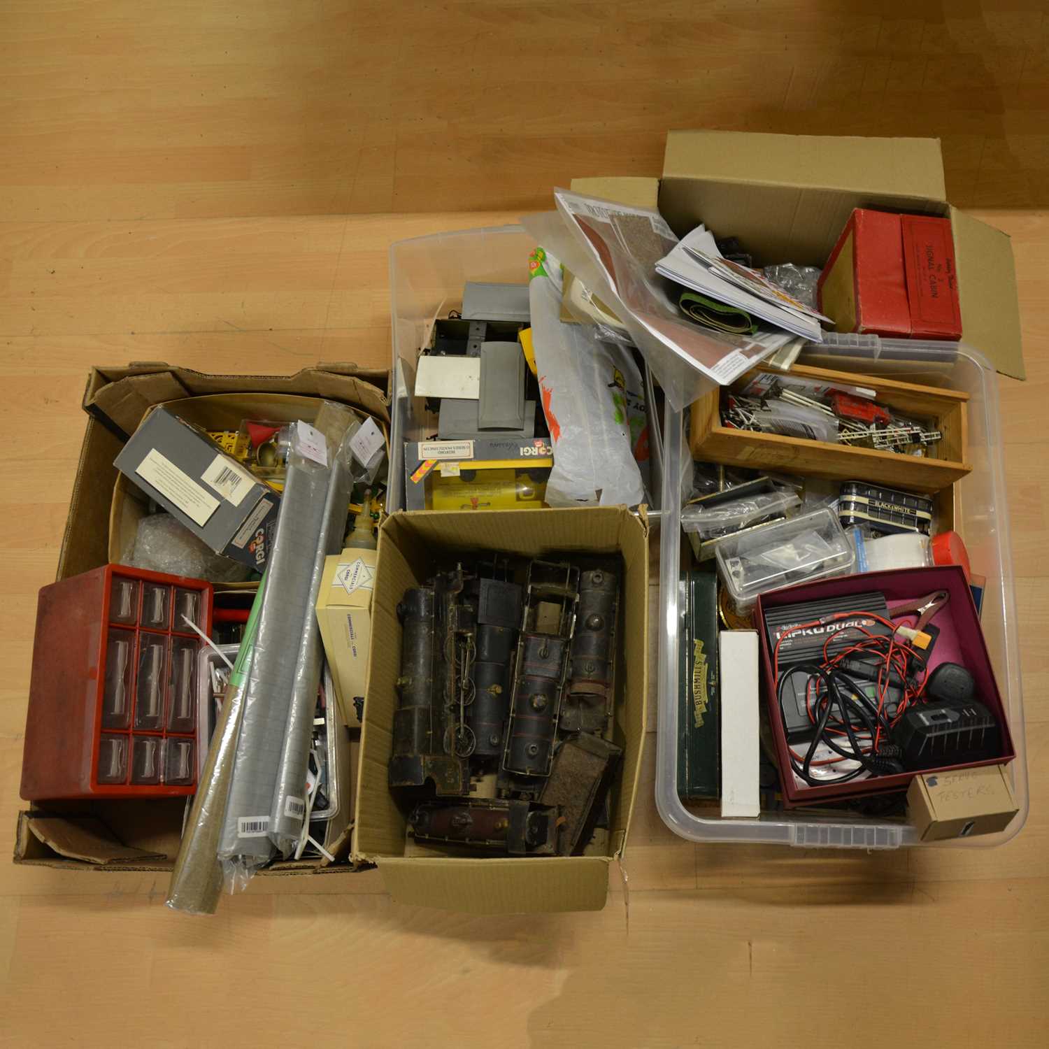 Lot 264 - Four boxes of model railway spare parts, equipment, etc.