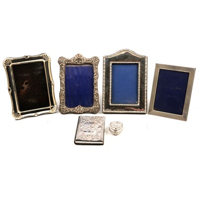 Lot 172 - Two silver topped cologne bottles, pill box, two silver frames and address book.