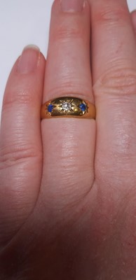 Lot 22 - A sapphire and diamond gypsy set ring.