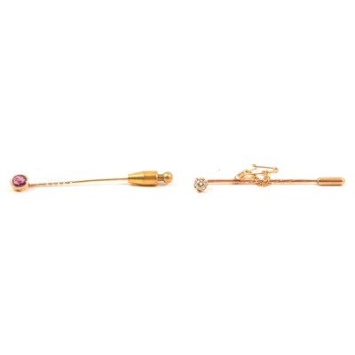 Lot 323 - A diamond tie pin and a garnet tie pin.