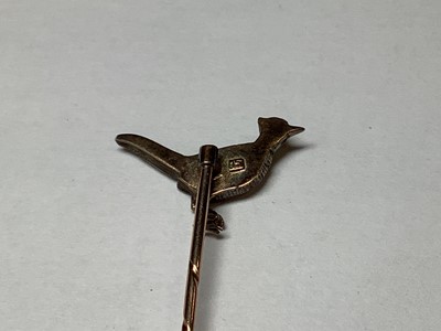 Lot 324 - A diamond and enamel pheasant tie pin.
