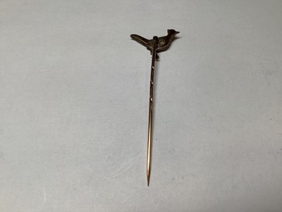 Lot 324 - A diamond and enamel pheasant tie pin.