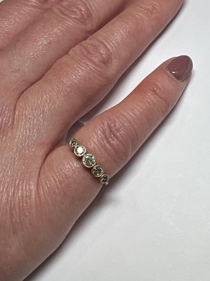 Lot 56 - A diamond five stone ring.
