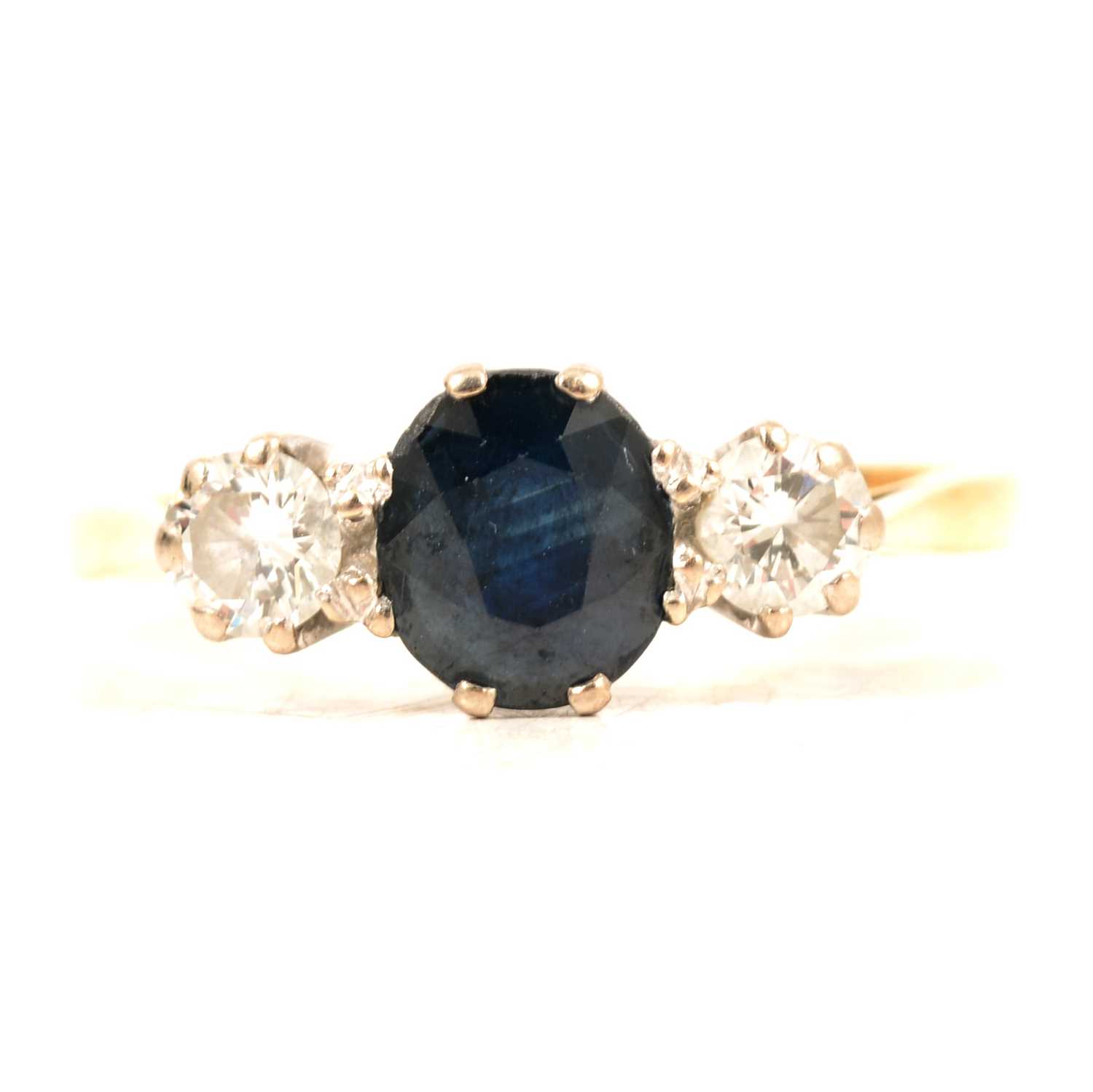 Lot 17 - A sapphire and diamond three stone ring.