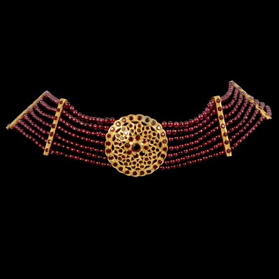 Lot 296 - A seven strand garnet bead choker necklace with gold-plated mounts.