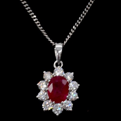Lot 10 - A ruby and diamond cluster pendant and chain.