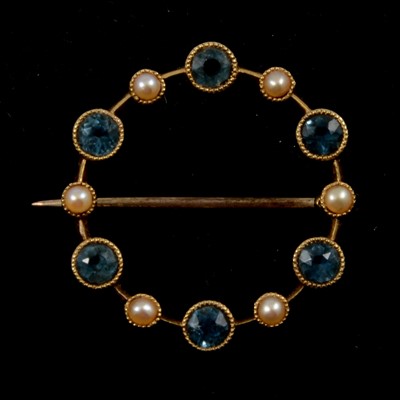 Lot 188 - A seed pearl  and pale blue stone garland brooch.