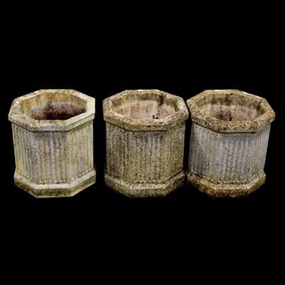 Lot 483 - Stone urn shaped pedestal planter, three octagonal fluted pots