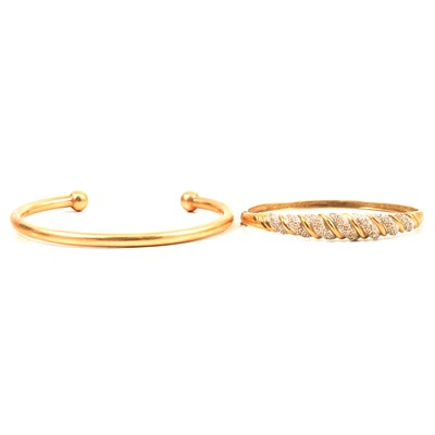 Lot 218 - Two 9 carat yellow gold modern bangles.