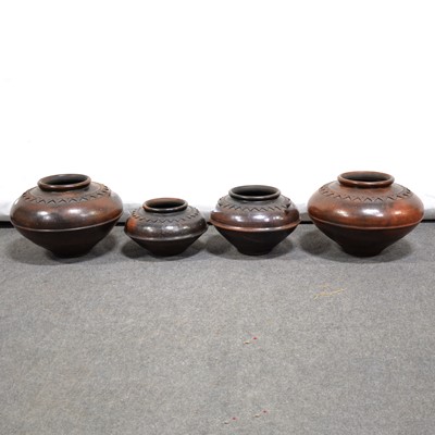 Lot 558 - Four large decorative earthenware vessels, burnished finish