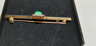 Lot 181 - An opal and diamond bar brooch.