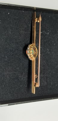 Lot 181 - An opal and diamond bar brooch.