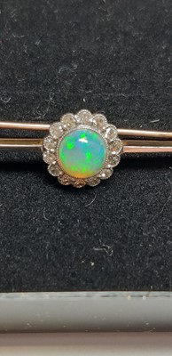 Lot 181 - An opal and diamond bar brooch.