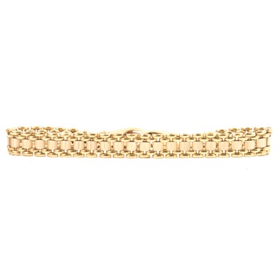 Lot 252 - A 9 carat yellow gold polished and bark textured bracelet.