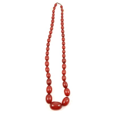 Lot 304 - A cherry coloured amber style bead necklace.