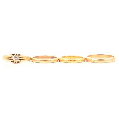 Lot 122 - A 22 carat yellow gold wedding ring, and three 18 carat gold rings.