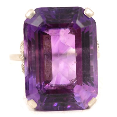 Lot 69 - A large amethyst dress ring with diamond shoulders.