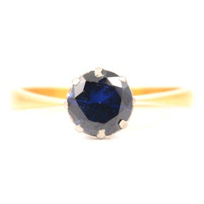 Lot 26 - A synthetic sapphire solitaire ring.