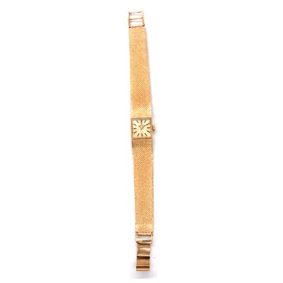 Lot 415 - Tissot - a lady's 9 carat yellow gold manual wind wristwatch.