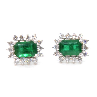 Lot 157 - A pair of emerald and diamond cluster earrings.