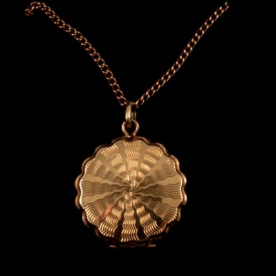 Lot 263 - A 9 carat yellow gold locket on a yellow metal curb link chain.