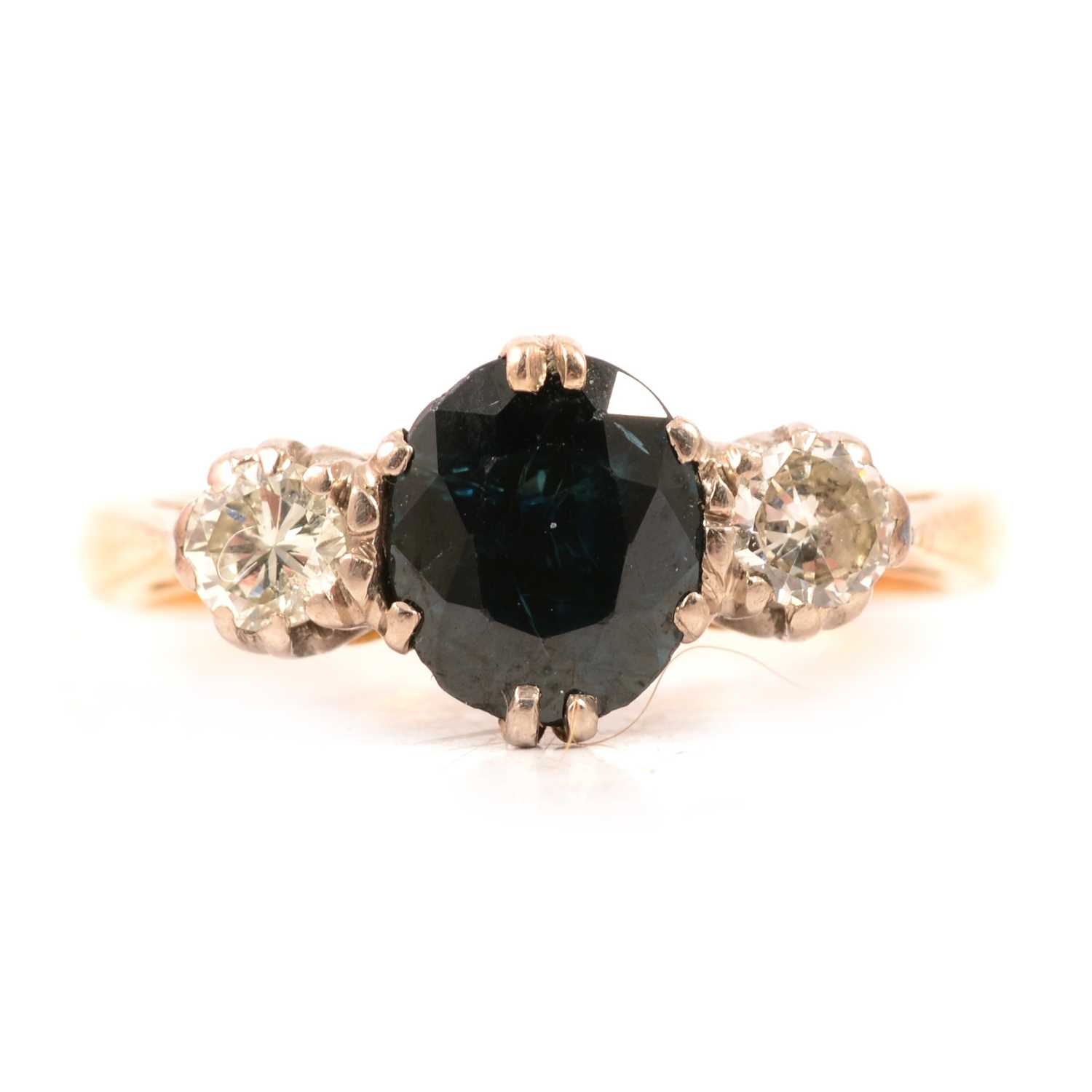 Lot 18 - A sapphire and diamond three stone ring.