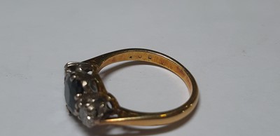 Lot 18 - A sapphire and diamond three stone ring.