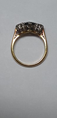 Lot 18 - A sapphire and diamond three stone ring.