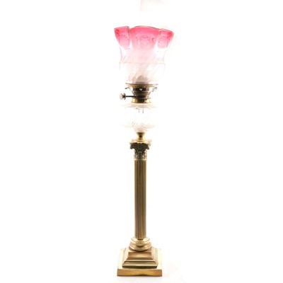 Lot 488 - Victorian brass oil lamp, cranberry shade