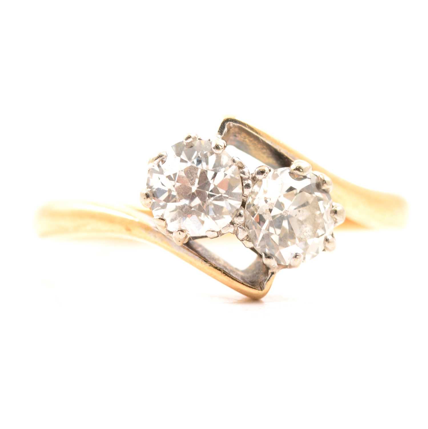 Lot 43 - A diamond two stone crossover ring.