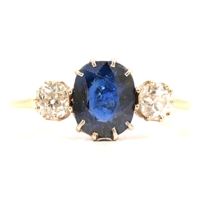 Lot 49 - A sapphire and diamond three stone ring.